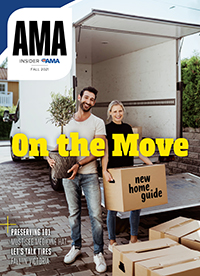Cover of AMA Insider Fall 2021 with smiling couple holding boxes in front of moving truck