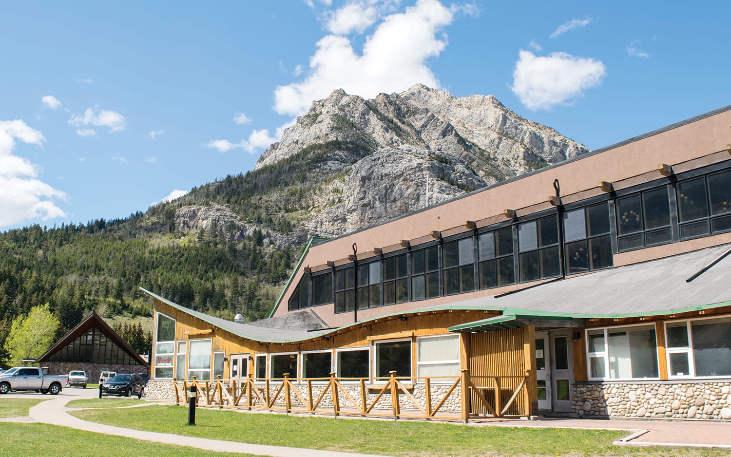 Two-storey wood building in Waterton with mountain behind