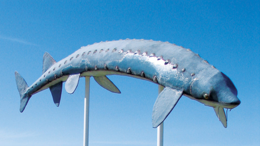 metal sturgeon fish on poles as a roadside attraction in manitoba
